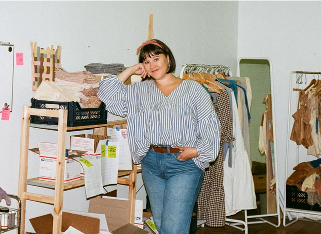 Meghan standing next to the shelf in the studio