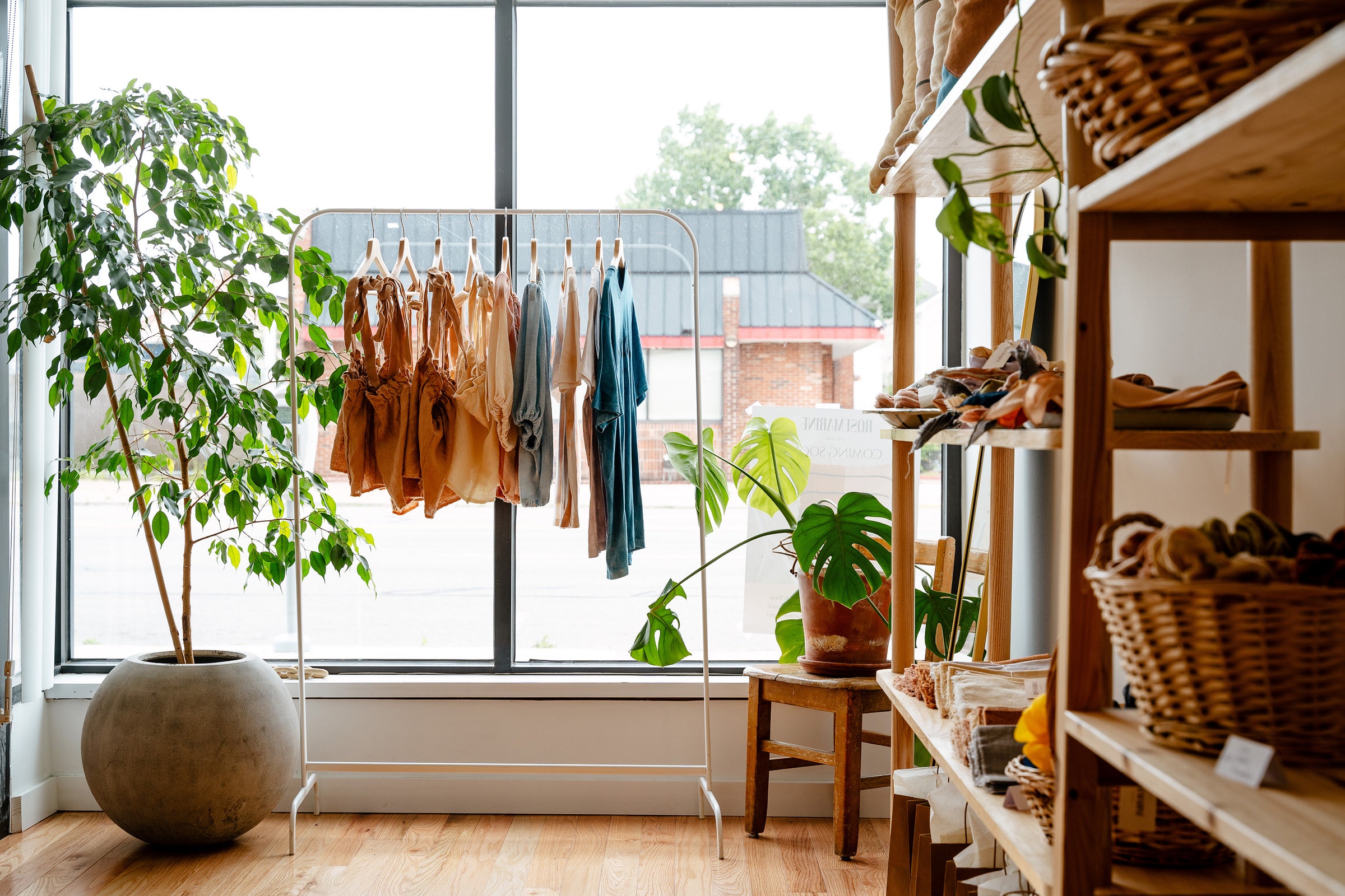 Rosemarine Textiles Hamtramck Studio inside clothing rack and shelves with plants